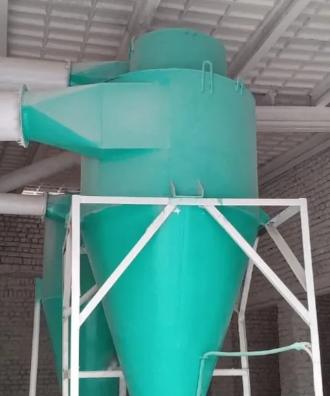 Teal cyclone separator installed in a processing shed.