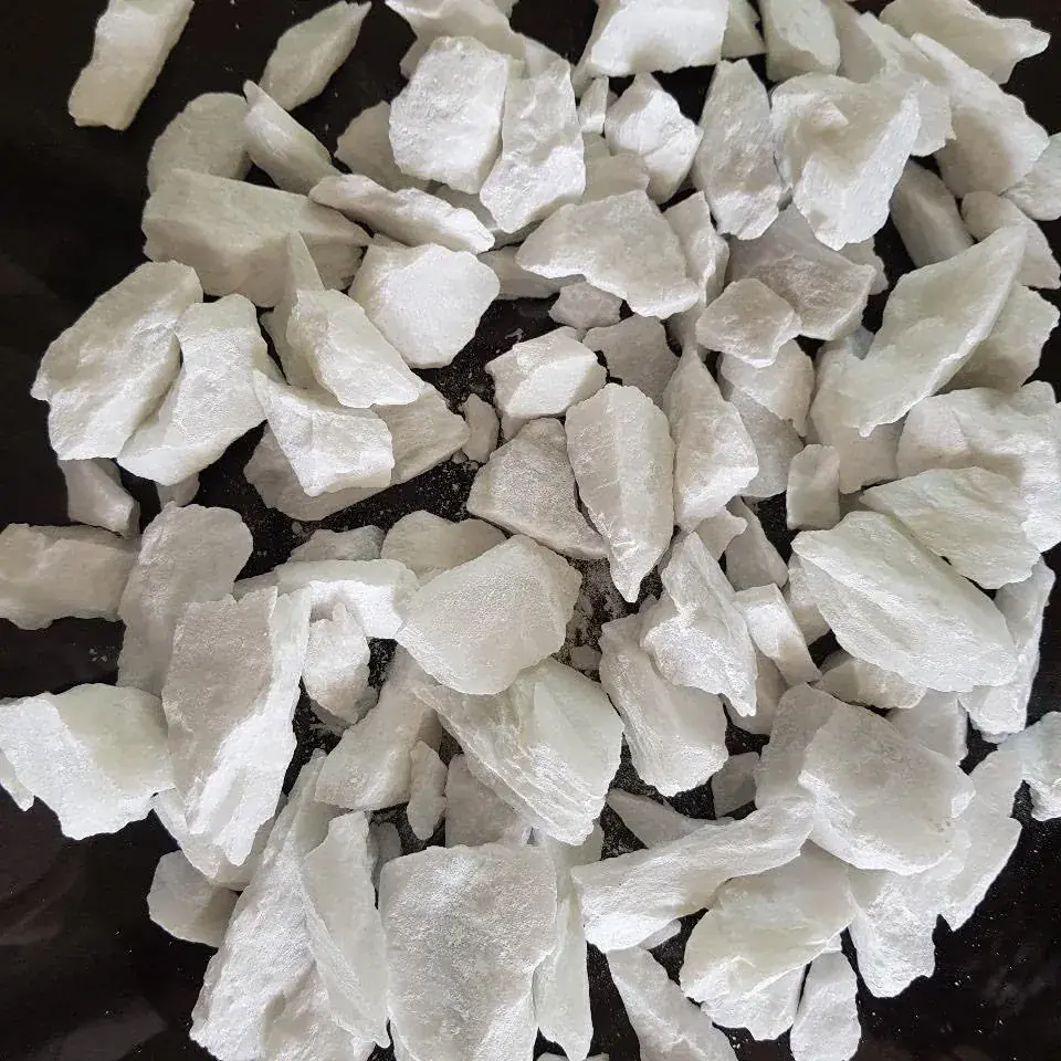 White talc lumps arranged on a black background.