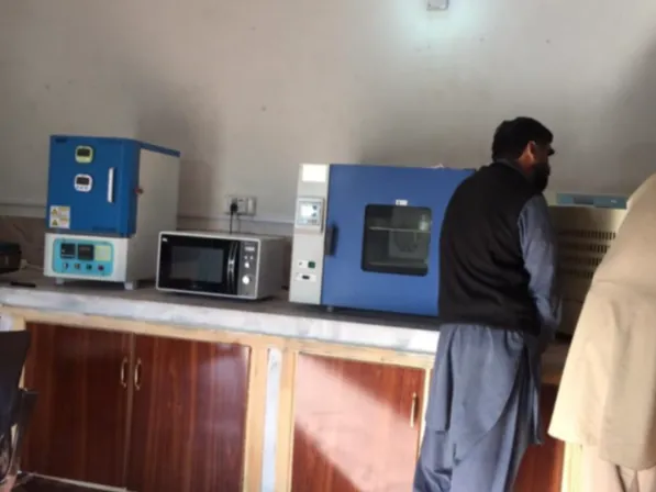 Laboratory bench with drying ovens and staff at work.