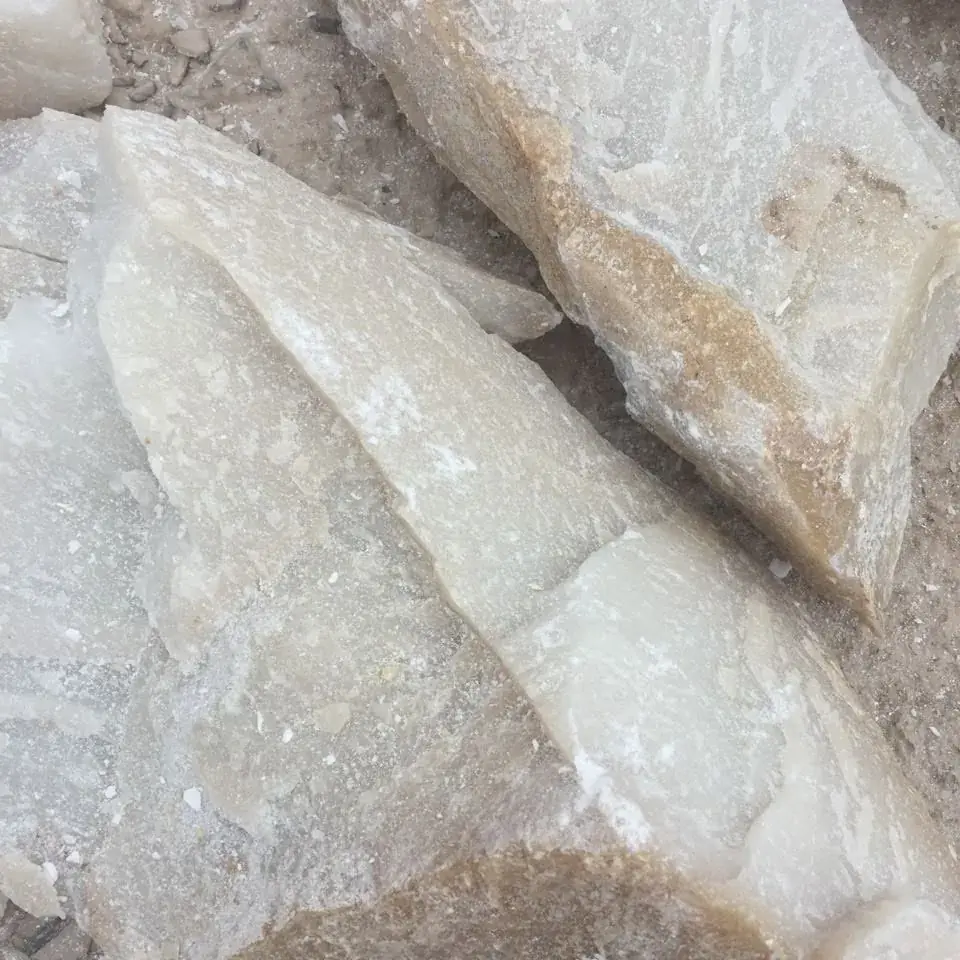 Close-up of pale, slightly translucent talc lumps.
