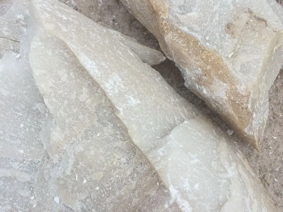 Close-up of pale, slightly translucent talc lumps.