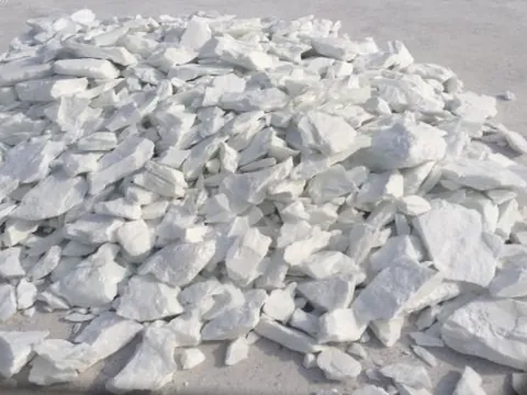 Close-up of flaky white talc lumps.